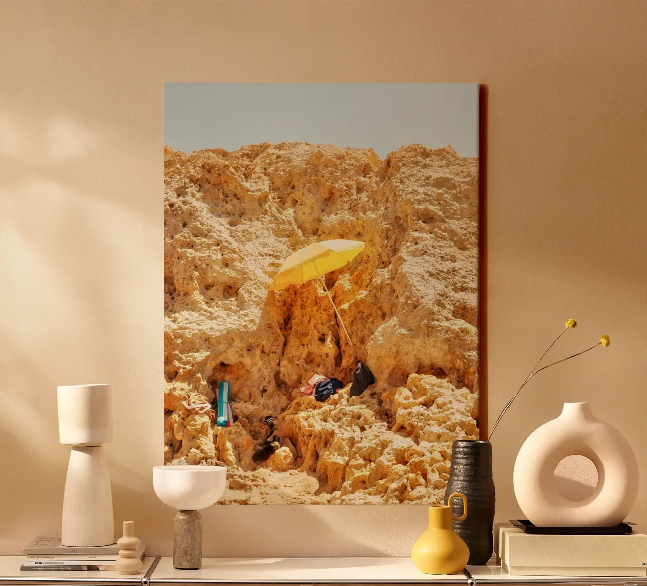Shelter in the Rocks – The Yellow Umbrella canvas with Floater frame by Thilo Grøsch