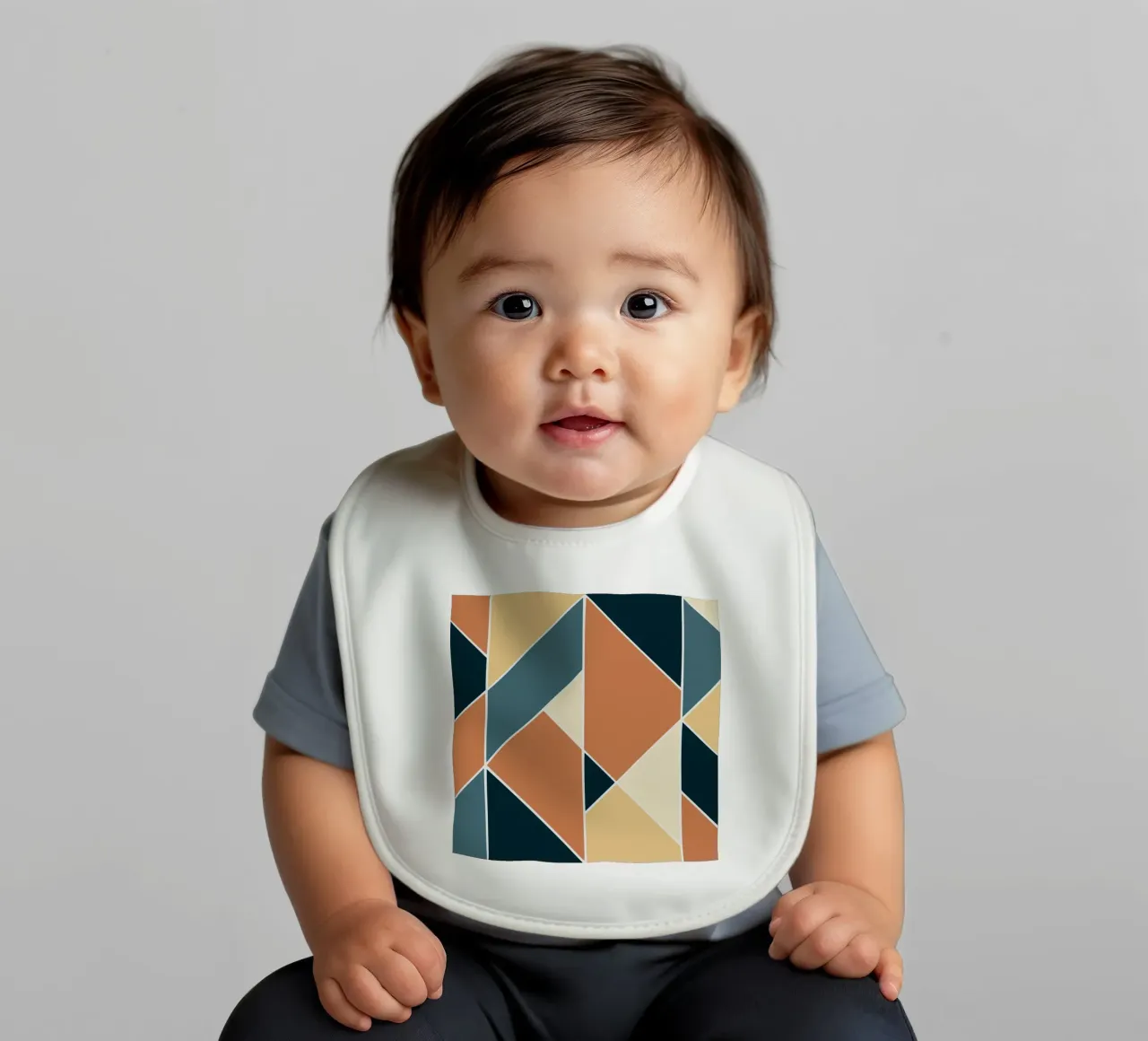 Geometric tile pattern baby bib by Little Dean