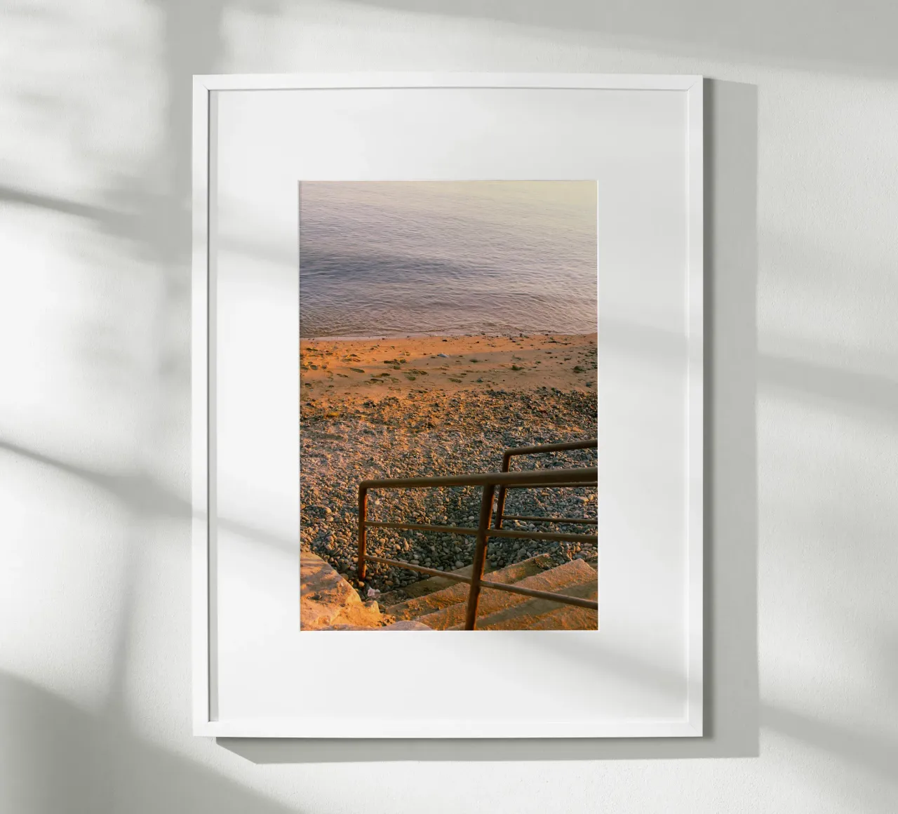 Scala rustica che conduce alla spiaggia di ciottoli al tramonto poster con telaio in alluminio da Liam Johnson
