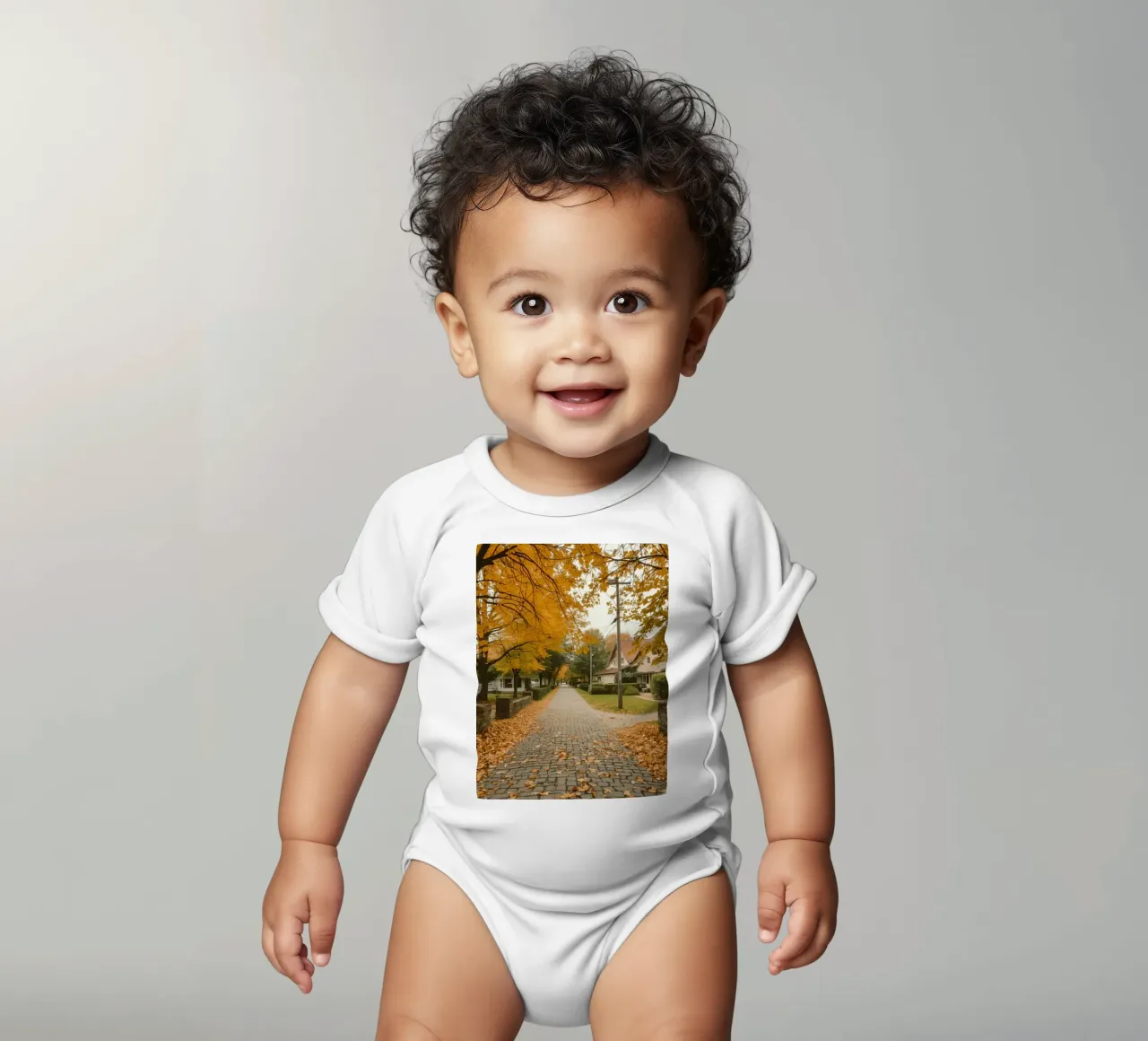 Cobblestone Path Lined with Autumn Trees and Houses short-sleeve baby romper by DesignDoodle