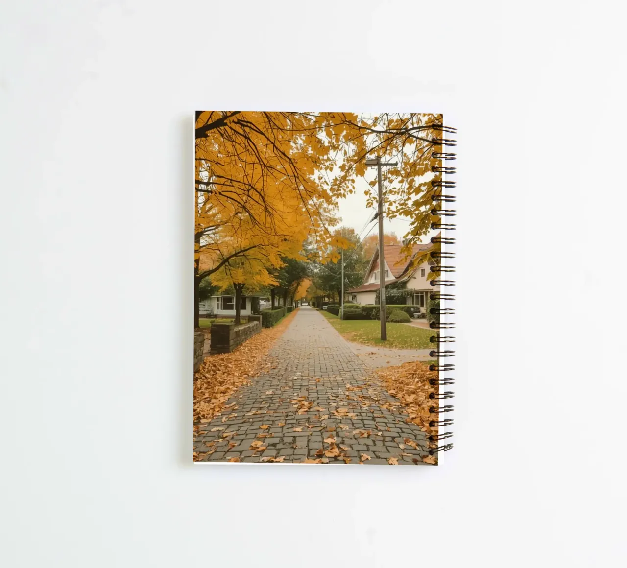 Cobblestone Path Lined with Autumn Trees and Houses spiral notebook by DesignDoodle