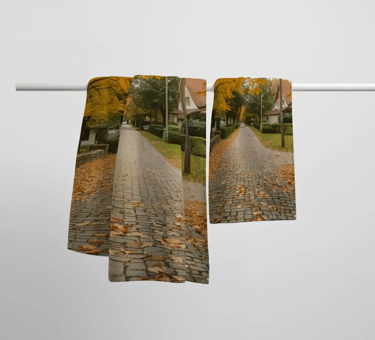 Cobblestone Path Lined with Autumn Trees and Houses towel by DesignDoodle