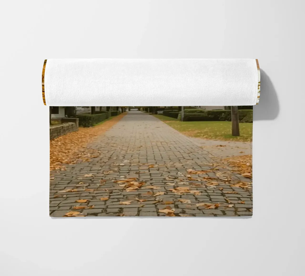 Cobblestone Path Lined with Autumn Trees and Houses beach towel by DesignDoodle