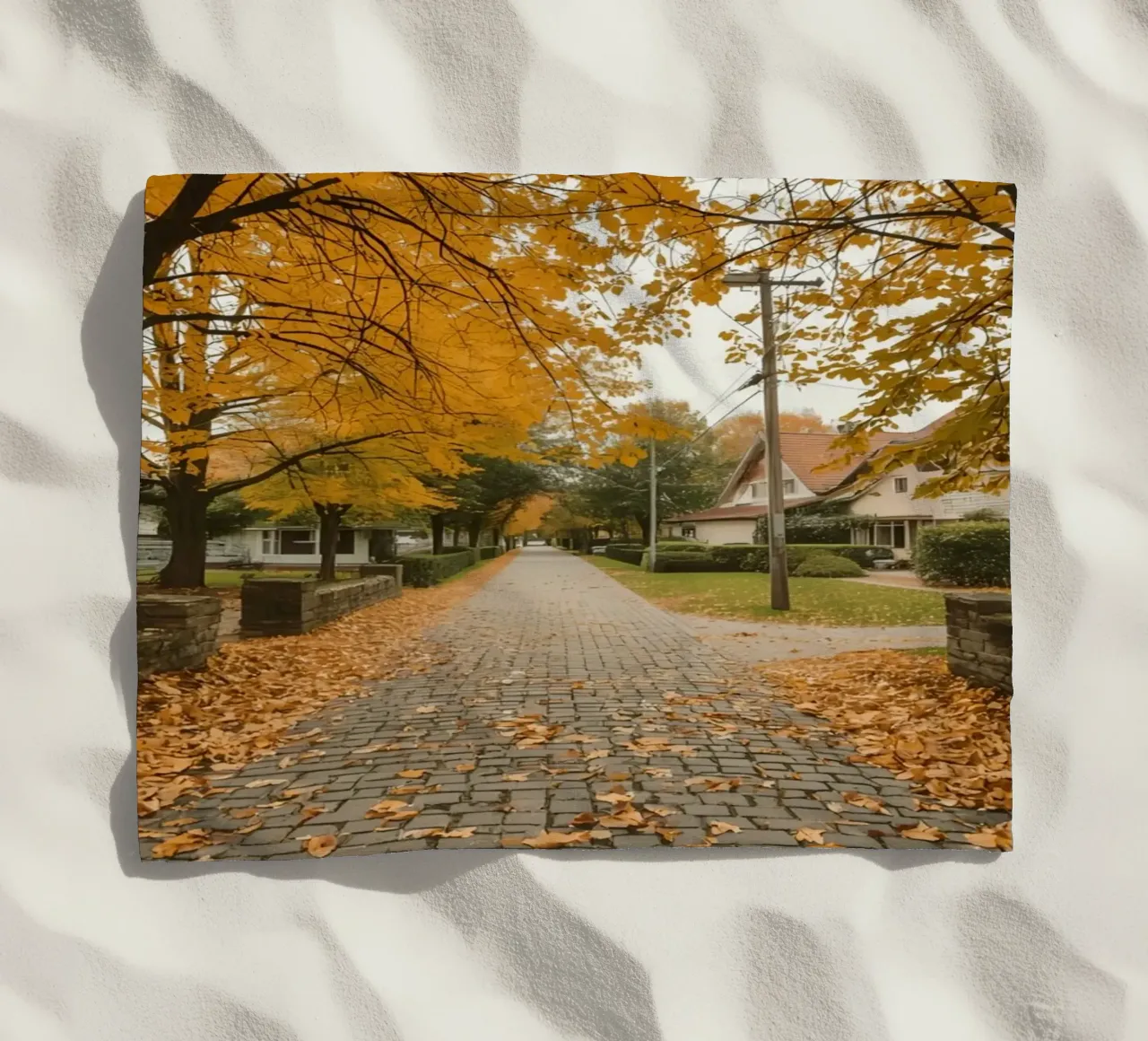 Cobblestone Path Lined with Autumn Trees and Houses beach towel by DesignDoodle