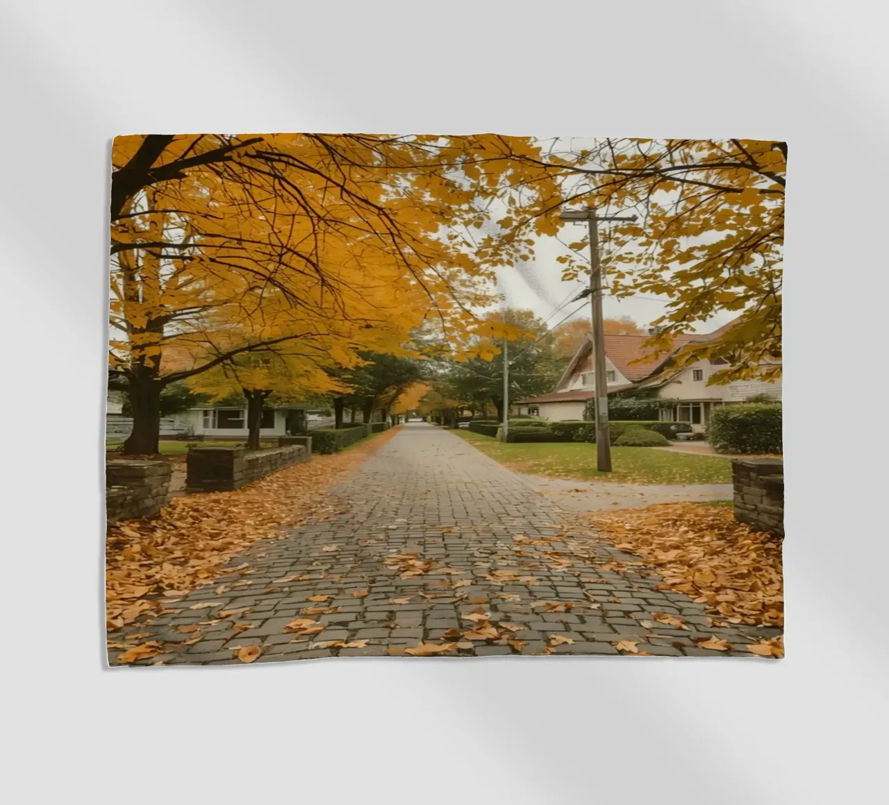 Cobblestone Path Lined with Autumn Trees and Houses beach towel by DesignDoodle