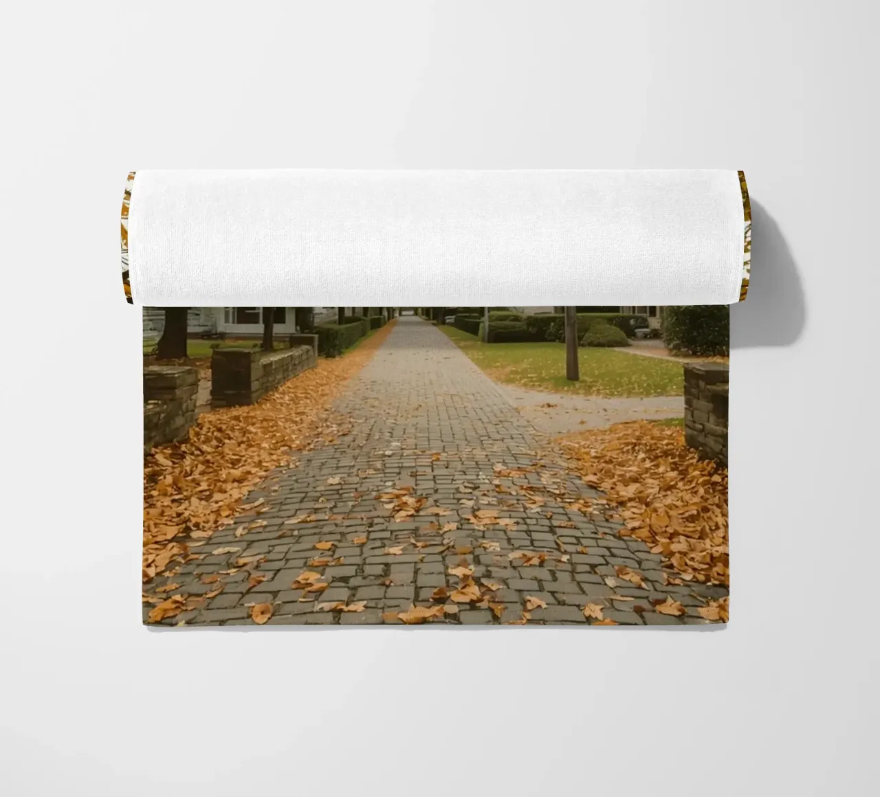 Cobblestone Path Lined with Autumn Trees and Houses beach towel by DesignDoodle