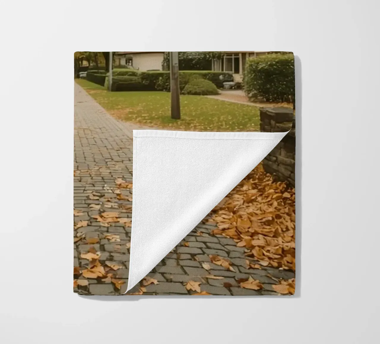 Cobblestone Path Lined with Autumn Trees and Houses beach towel by DesignDoodle