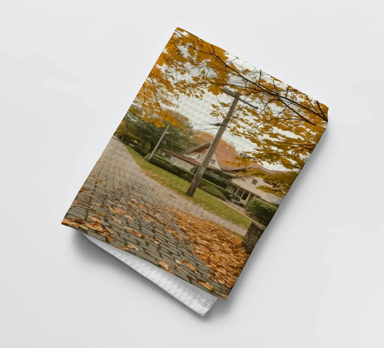 Cobblestone Path Lined with Autumn Trees and Houses tea towel by DesignDoodle