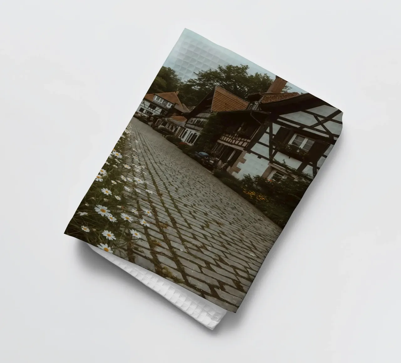 Cobblestone Path Lined with Autumn Trees and Houses tea towel by DesignDoodle