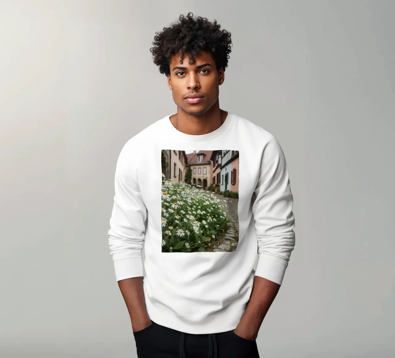 Margherite lungo una strada acciottolata con edifici felpa da DesignDoodle
