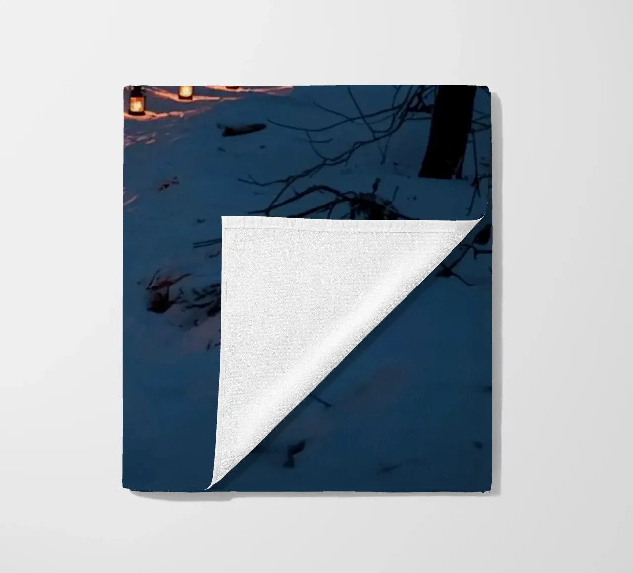 Snowy Forest Path Lined with Lanterns beach towel by DesignDoodle