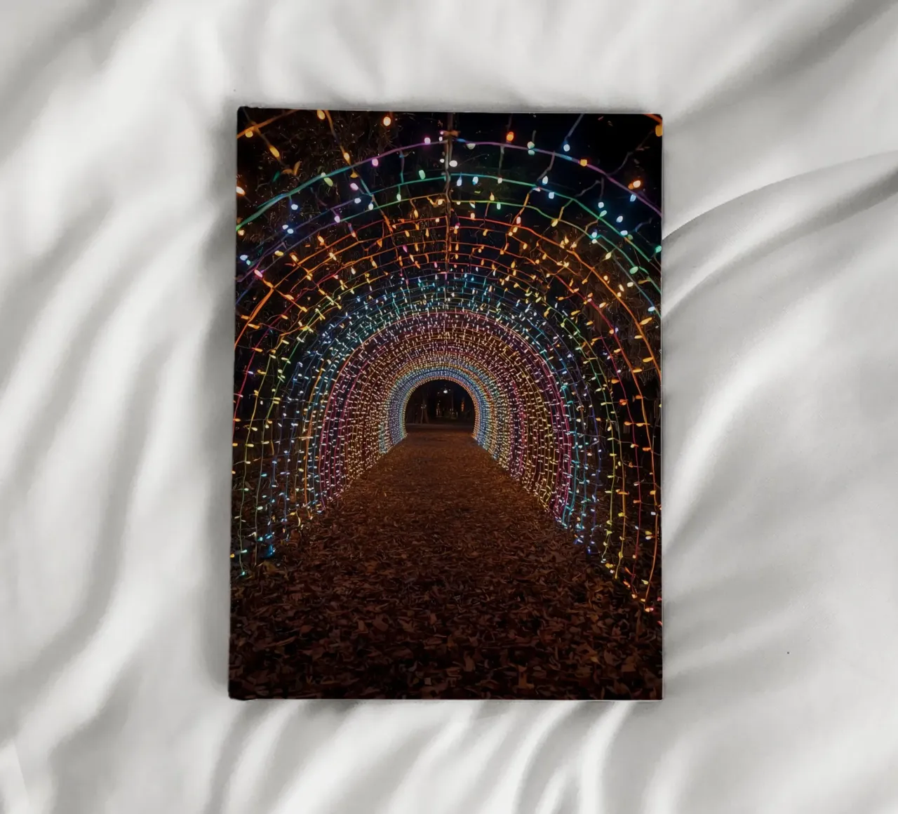 Archway Tunnel with Colorful Lights and Fallen Leaves notebook by DesignDoodle