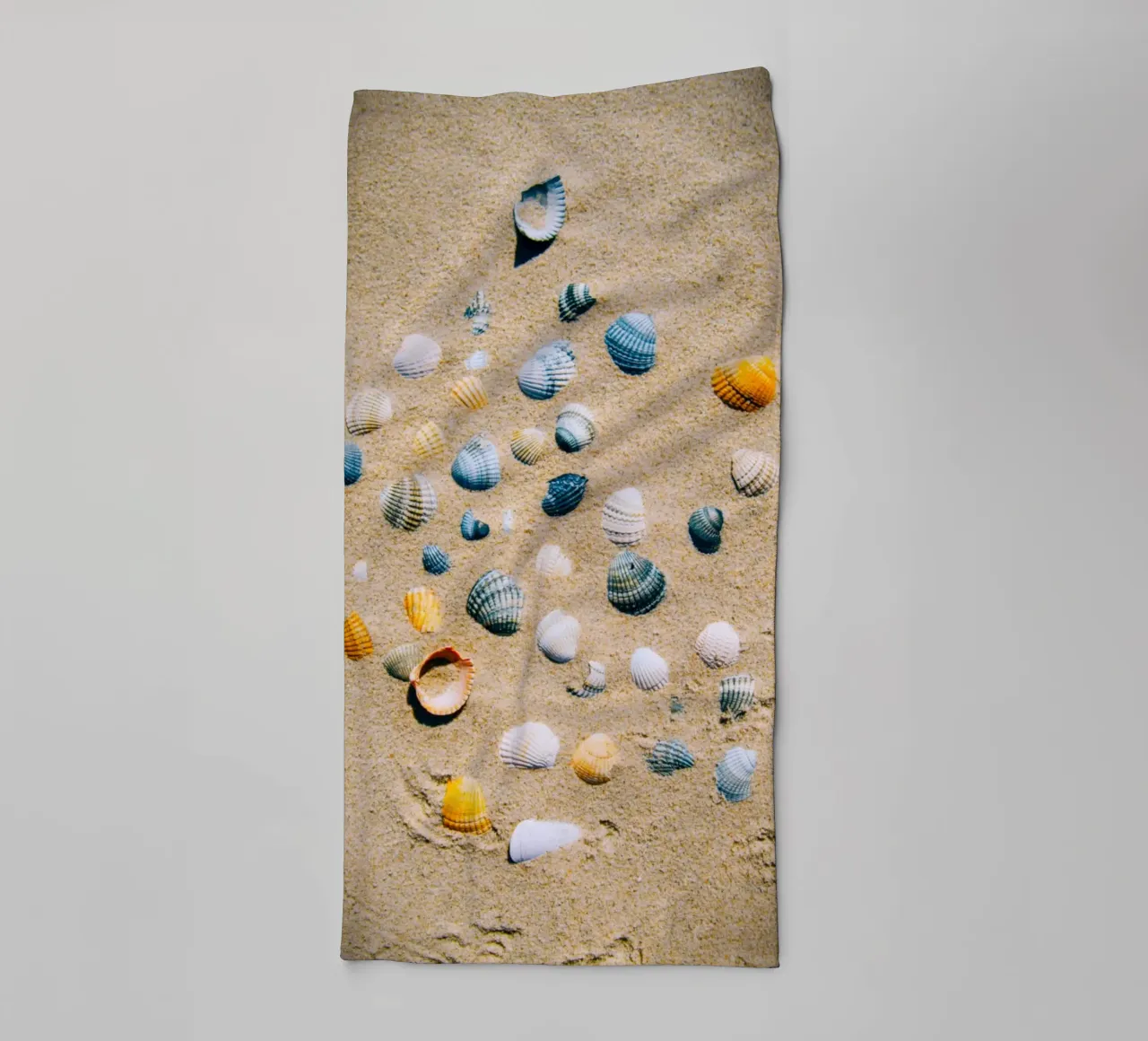 Shells on the sand – the ocean's eternal mark towel by Nature's Palette