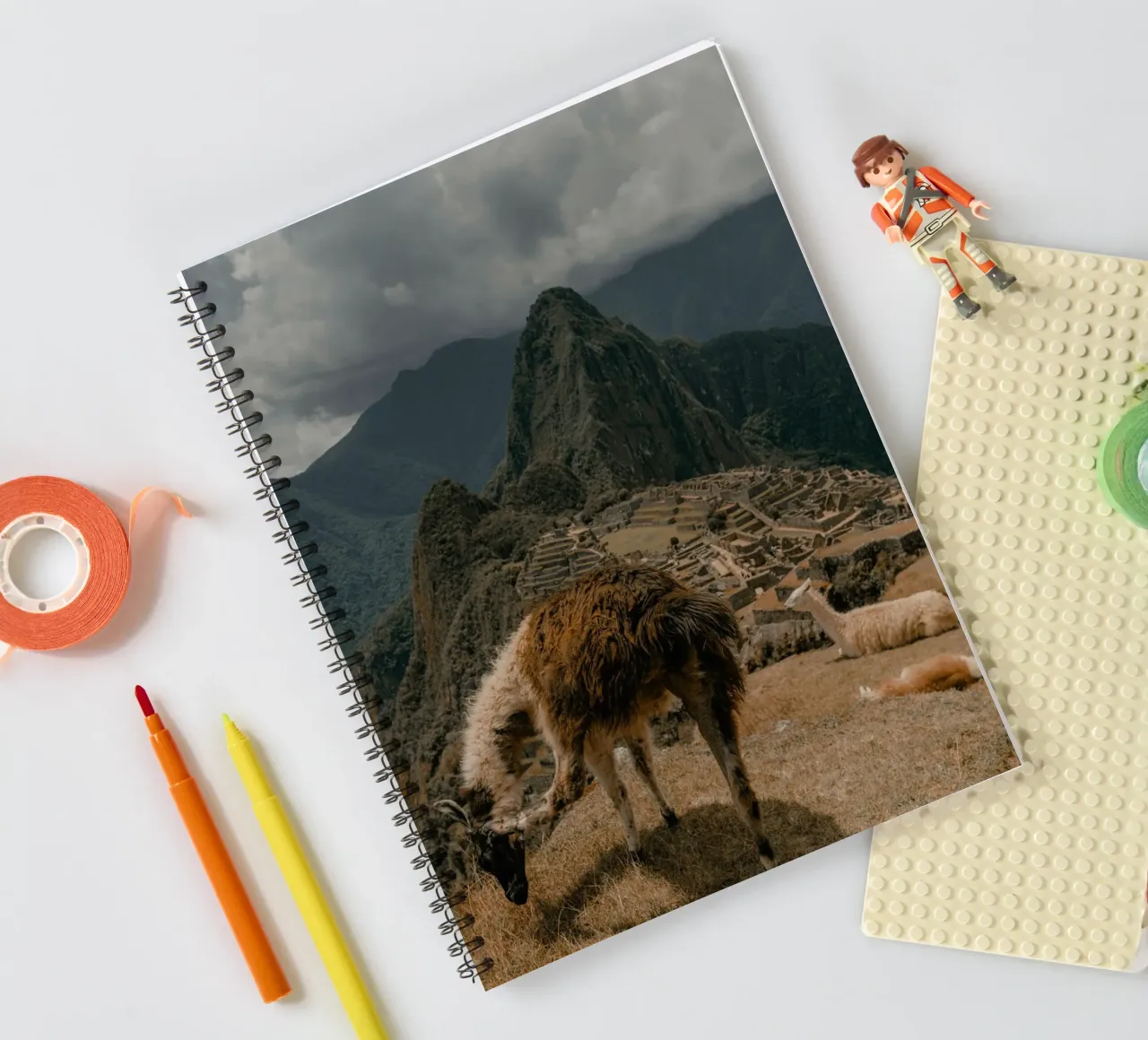 Llamas Grazing in the Foreground of Machu Picchu spiral notebook by The Herringstore
