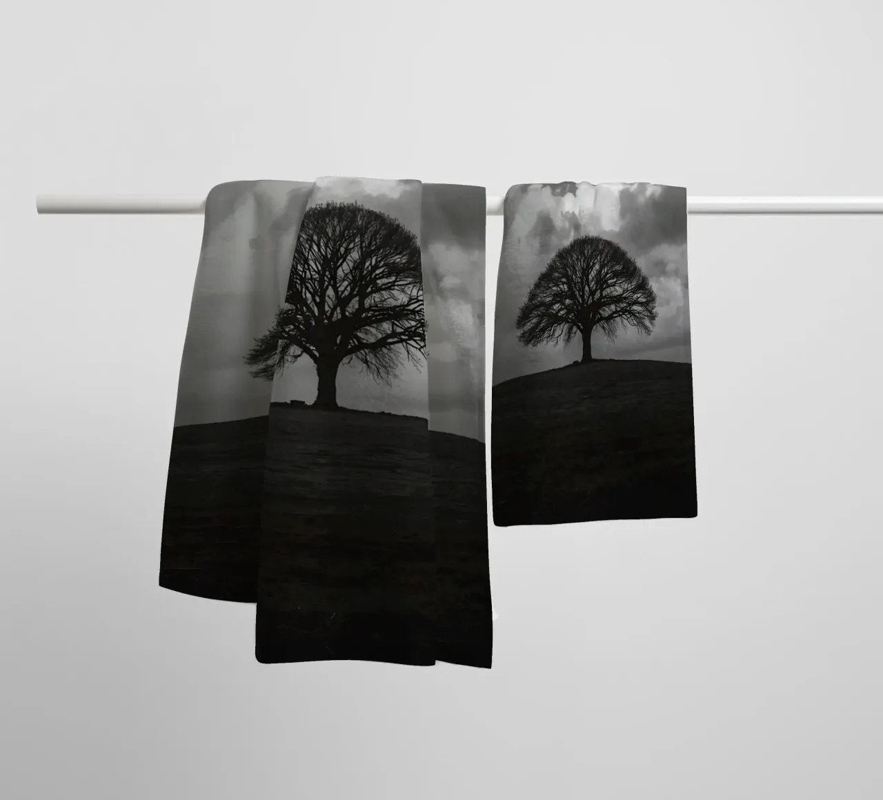 Deciduous Tree on Grassy Hill Under Cloudy Sky towel by DesignDoodle