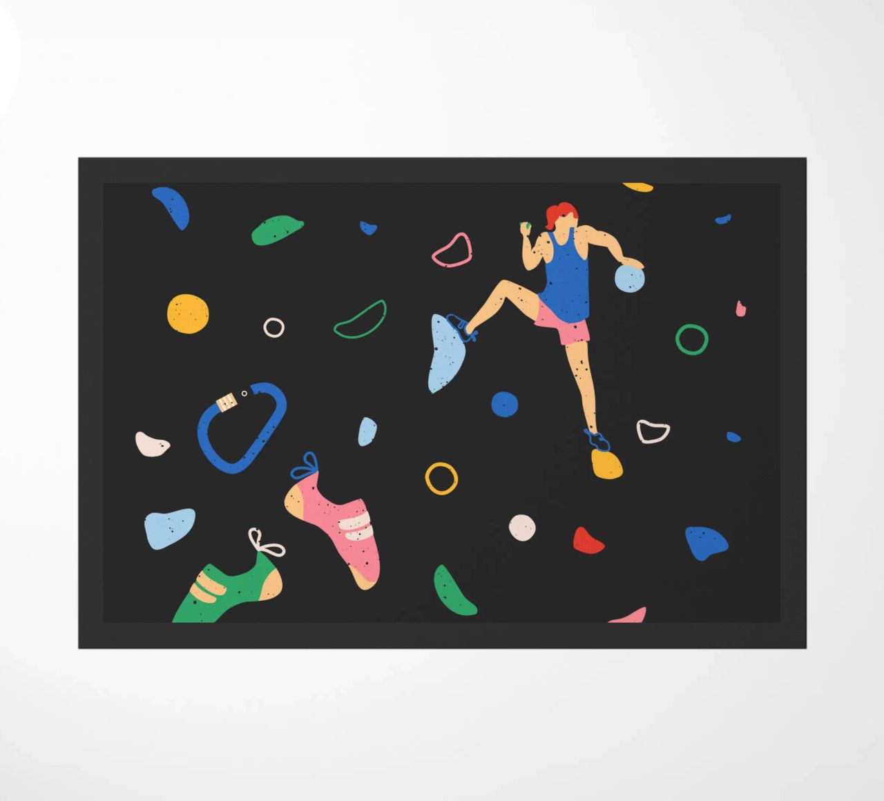 Arrampicatore su una parete di bouldering zerbino da justclimberthings
