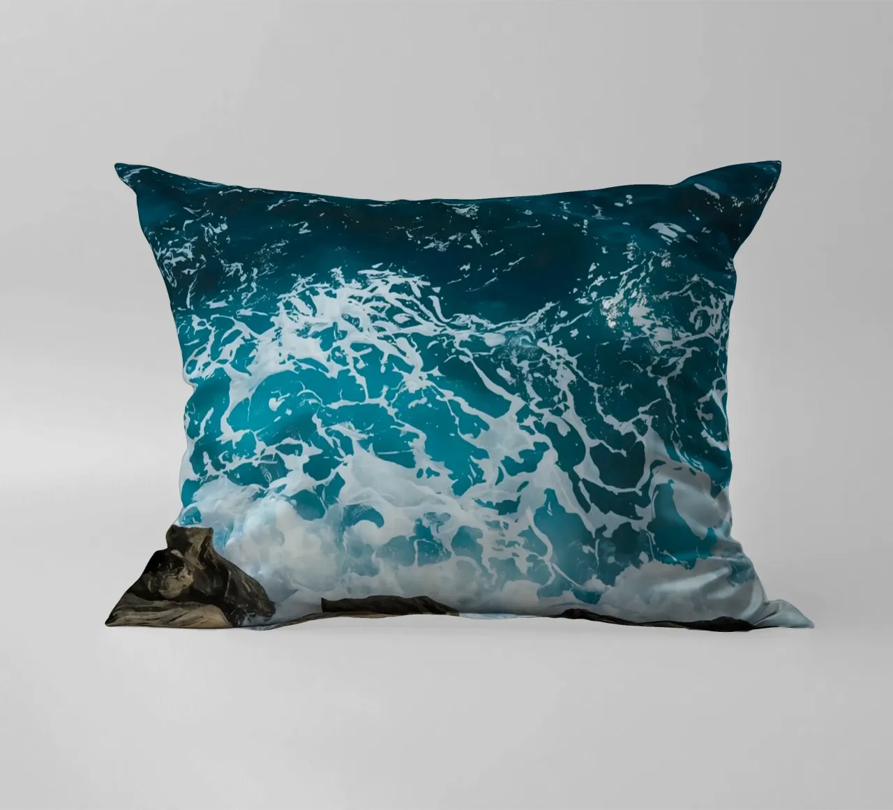 Onde oceaniche che si infrangono sulle rocce cuscino da DesignDoodle