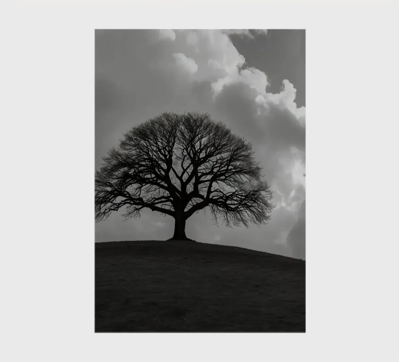 Silhouette of a bare tree on a hill against a cloudy sky notebook by DesignDoodle