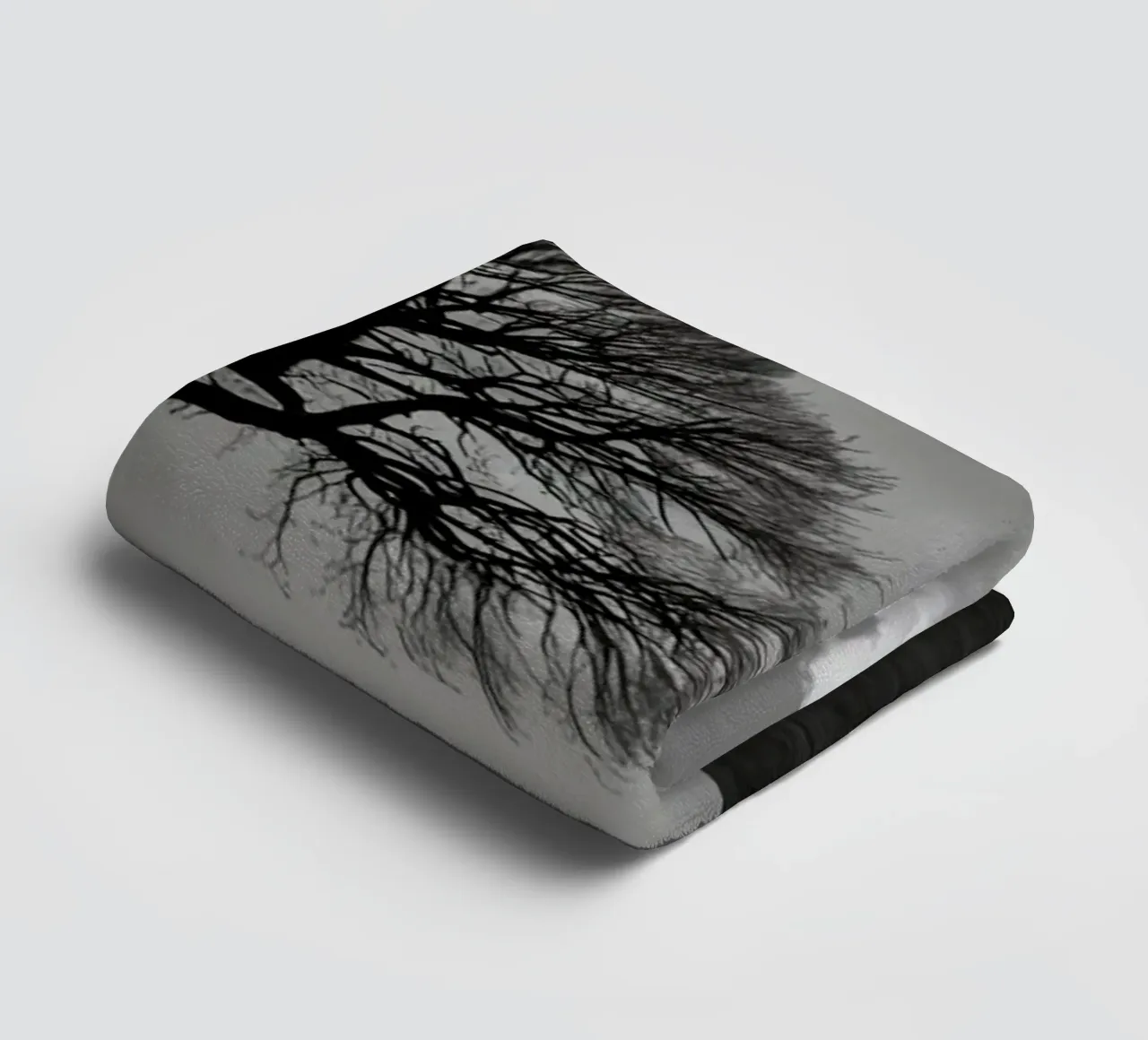 Silhouette of a bare tree on a hill against a cloudy sky towel by DesignDoodle