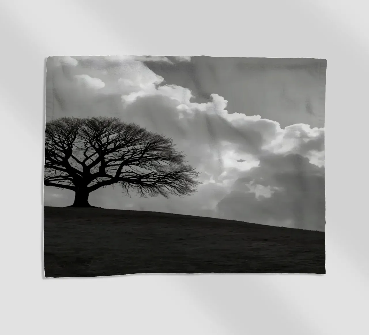 Sagoma di un albero spoglio su una collina contro un cielo nuvoloso telo mare da DesignDoodle