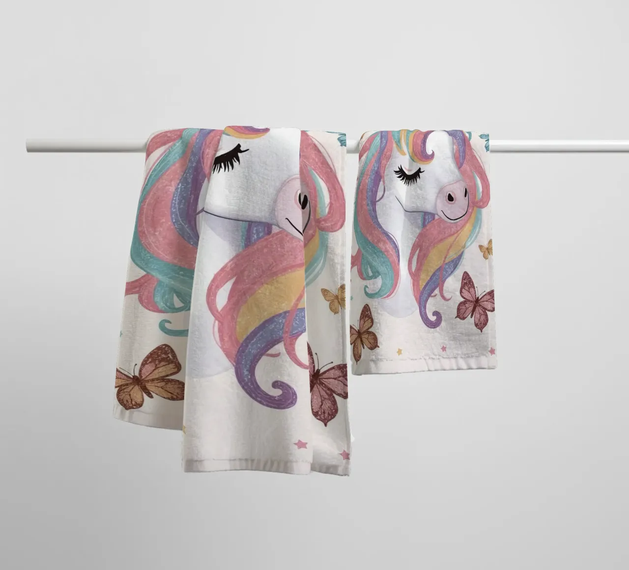 Unicorn with Rainbow Mane and Butterflies towel by DesignDoodle