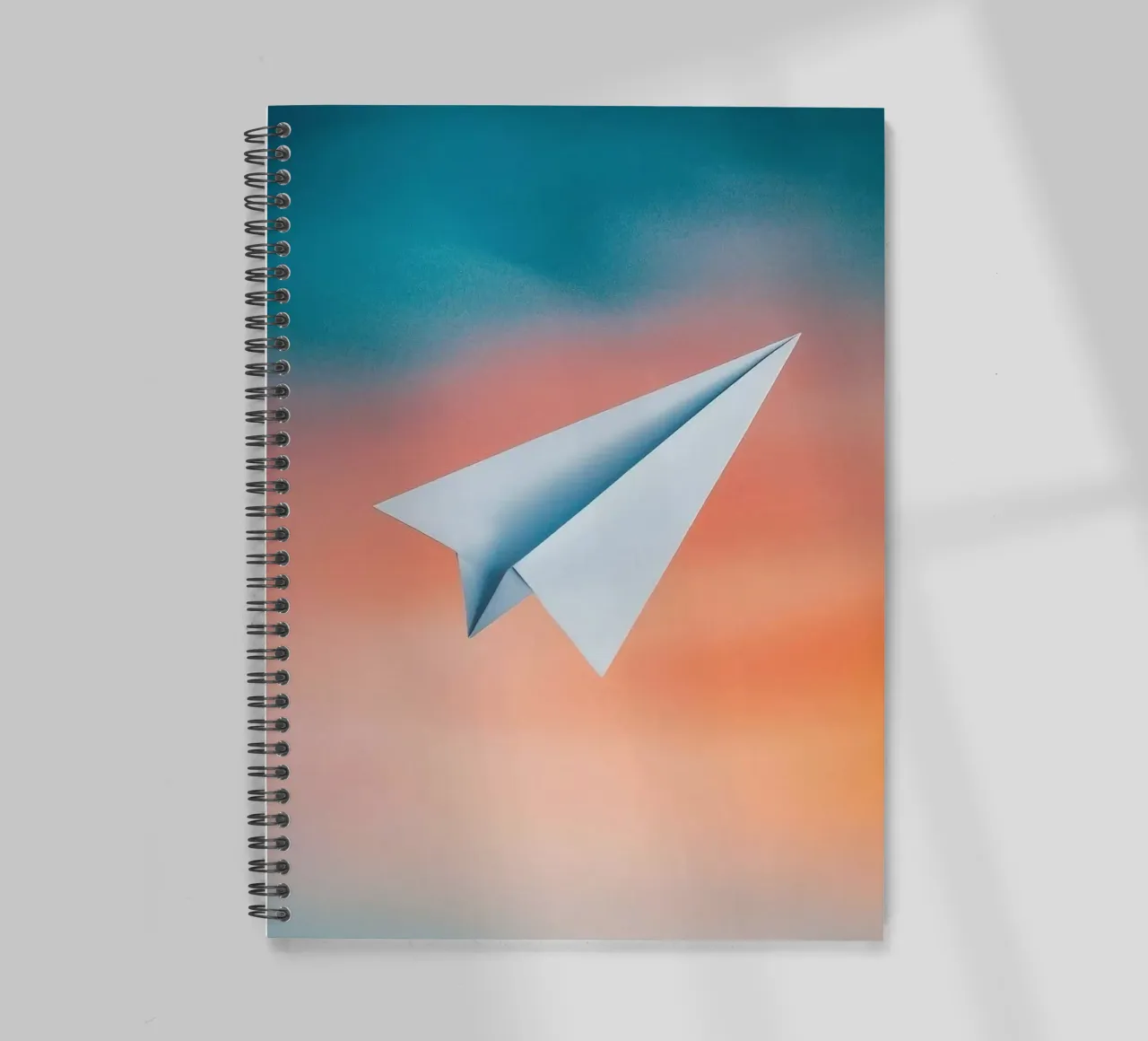paper plane in gradient spiral notebook by scoten