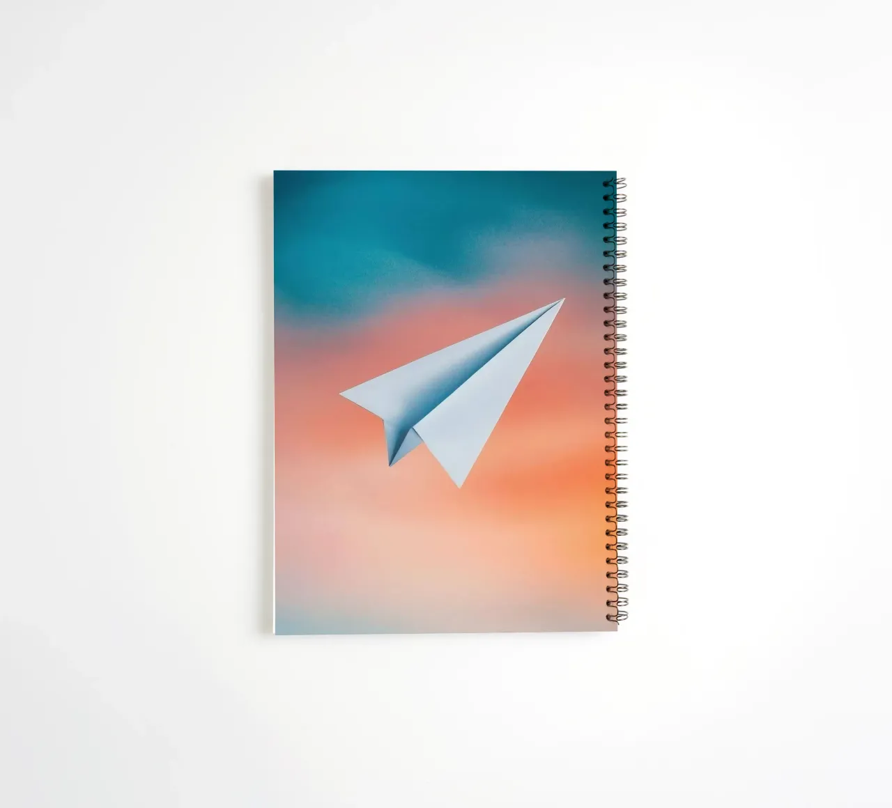 paper plane in gradient spiral notebook by scoten