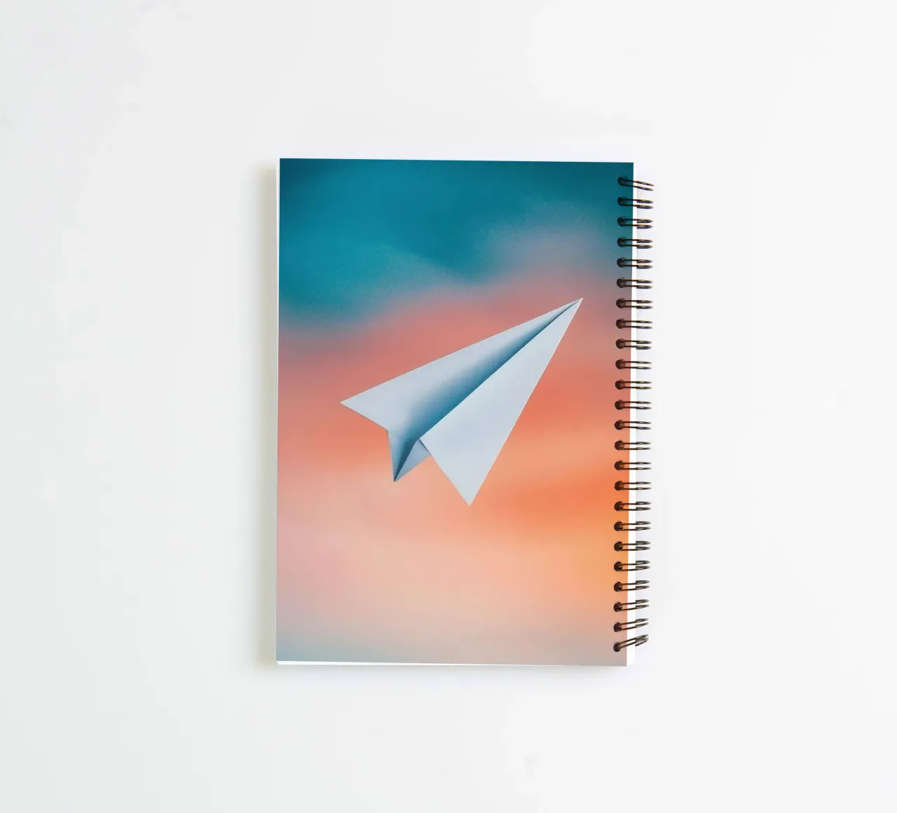 paper plane in gradient spiral notebook by scoten
