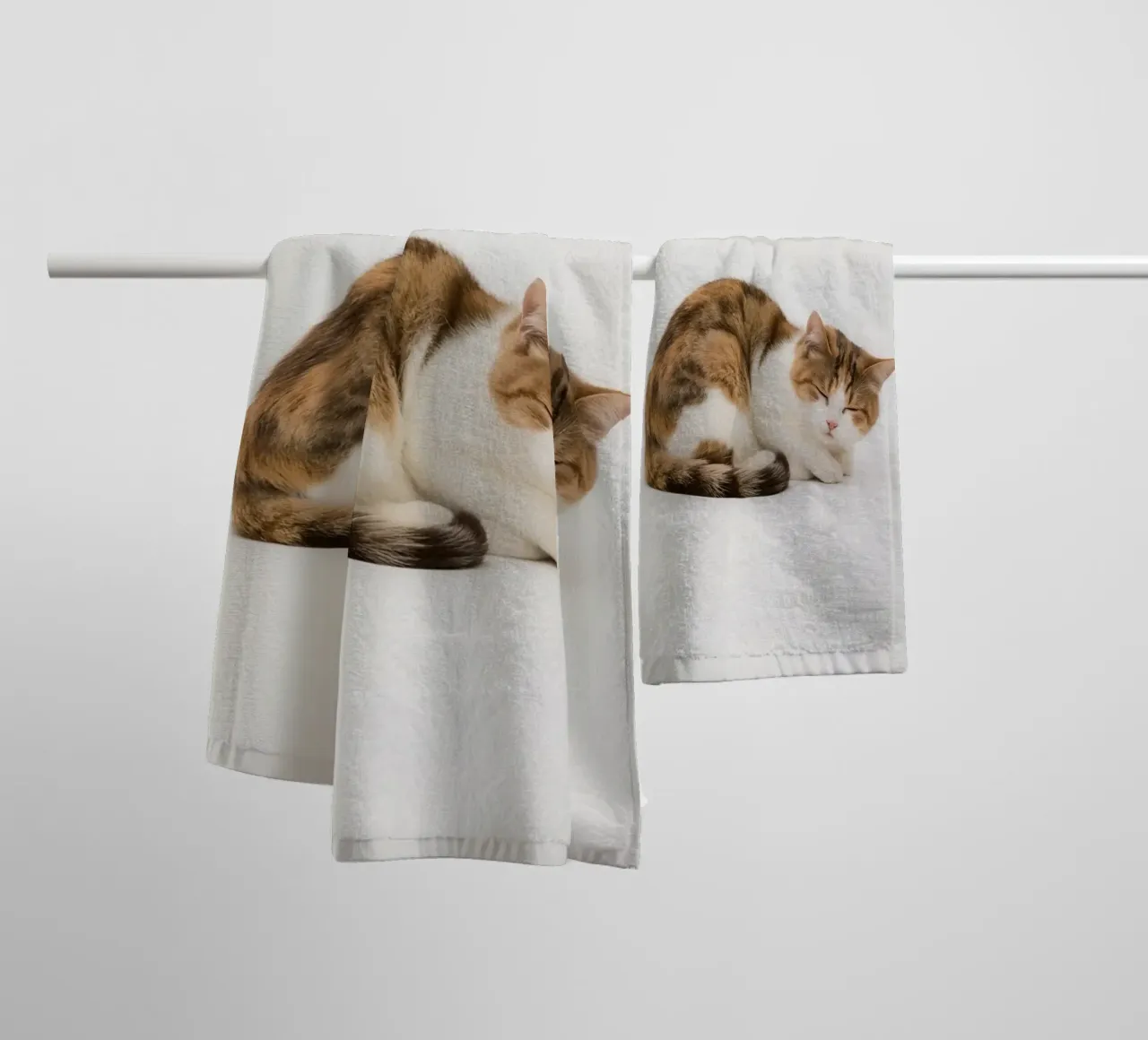 Calico cat sleeping on white background towel by DesignDoodle
