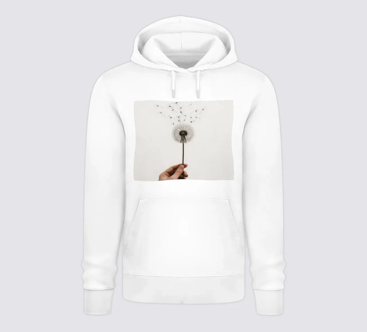 Mano que sostiene un diente de león con semillas voladoras sudadera con capucha de DesignDoodle