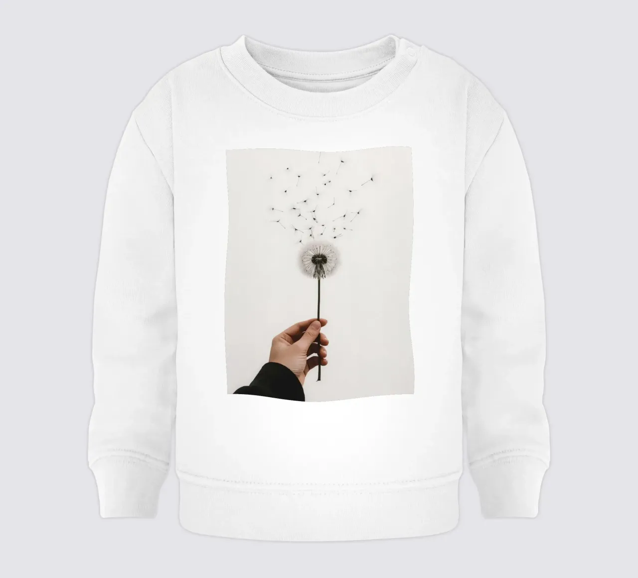 Mano que sostiene un diente de león con semillas voladoras sudadera de bebé de DesignDoodle