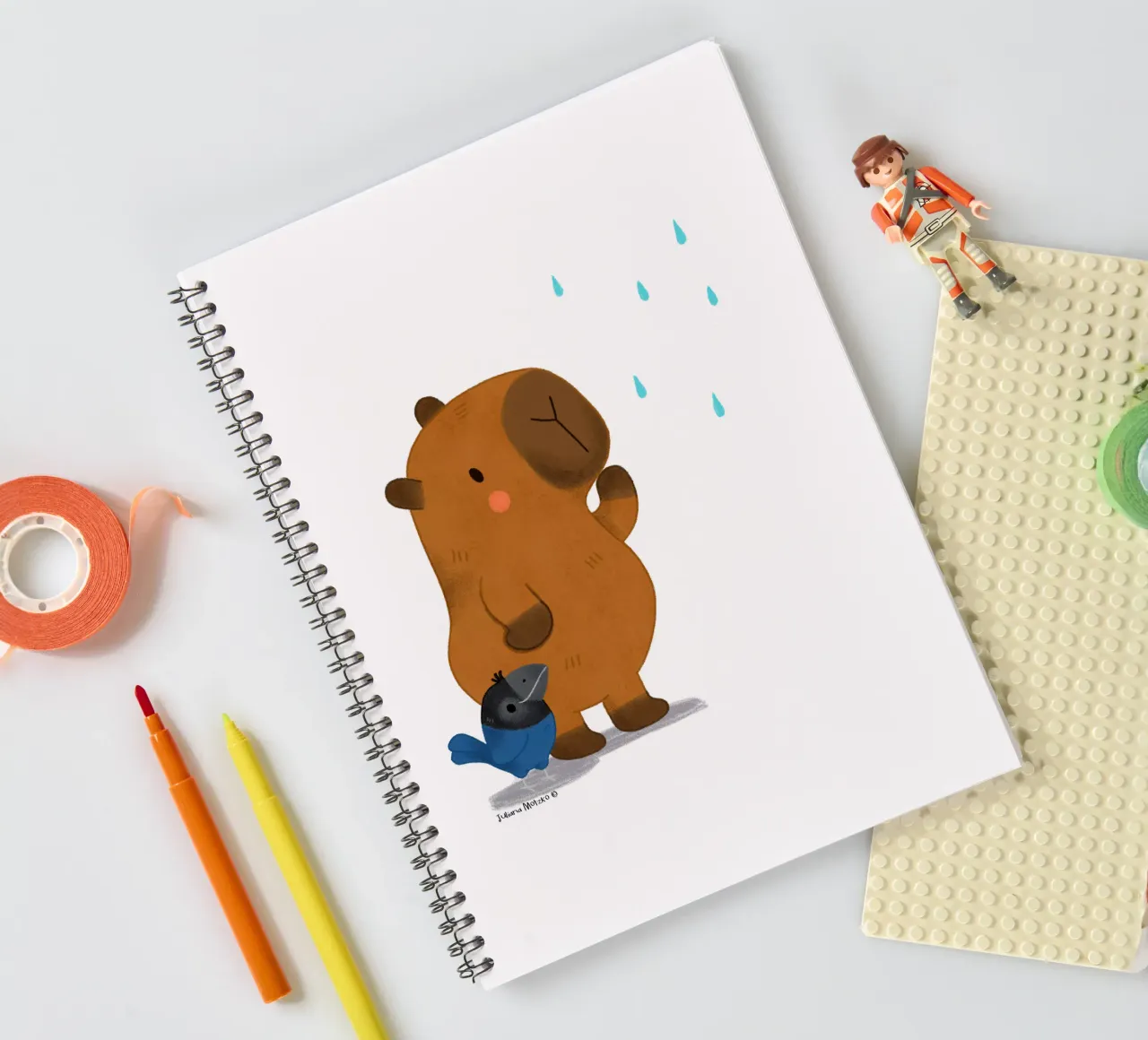 Capybara and Bird looking at the rain spiral notebook by julianamotzko