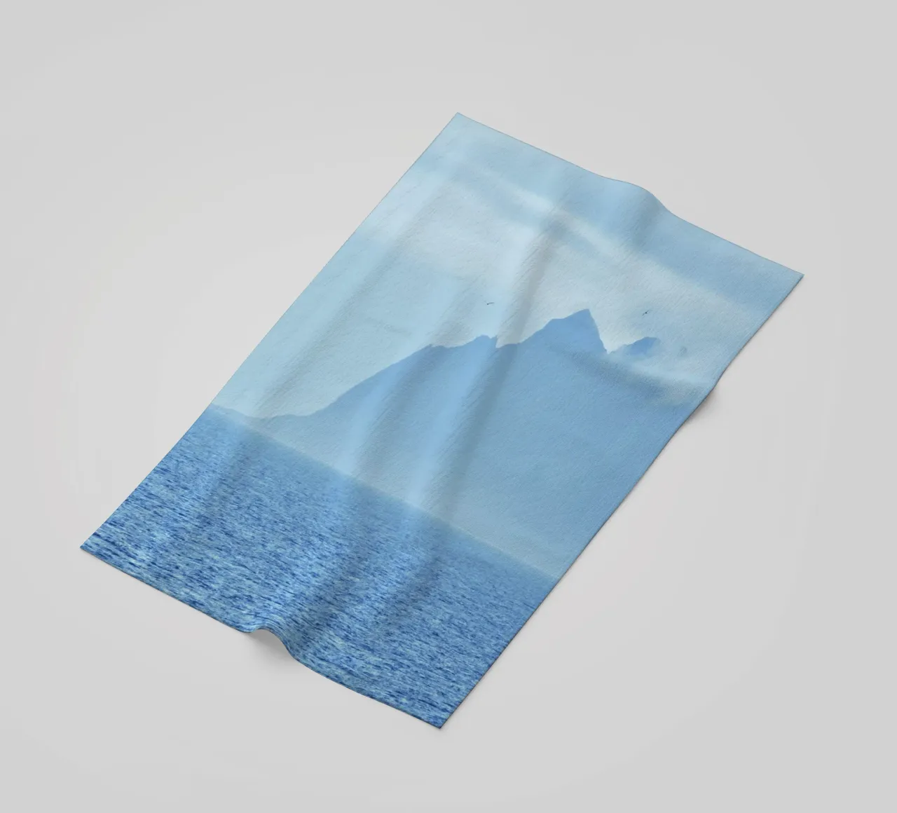 Mountains out of the sea beach towel by Fjöllart