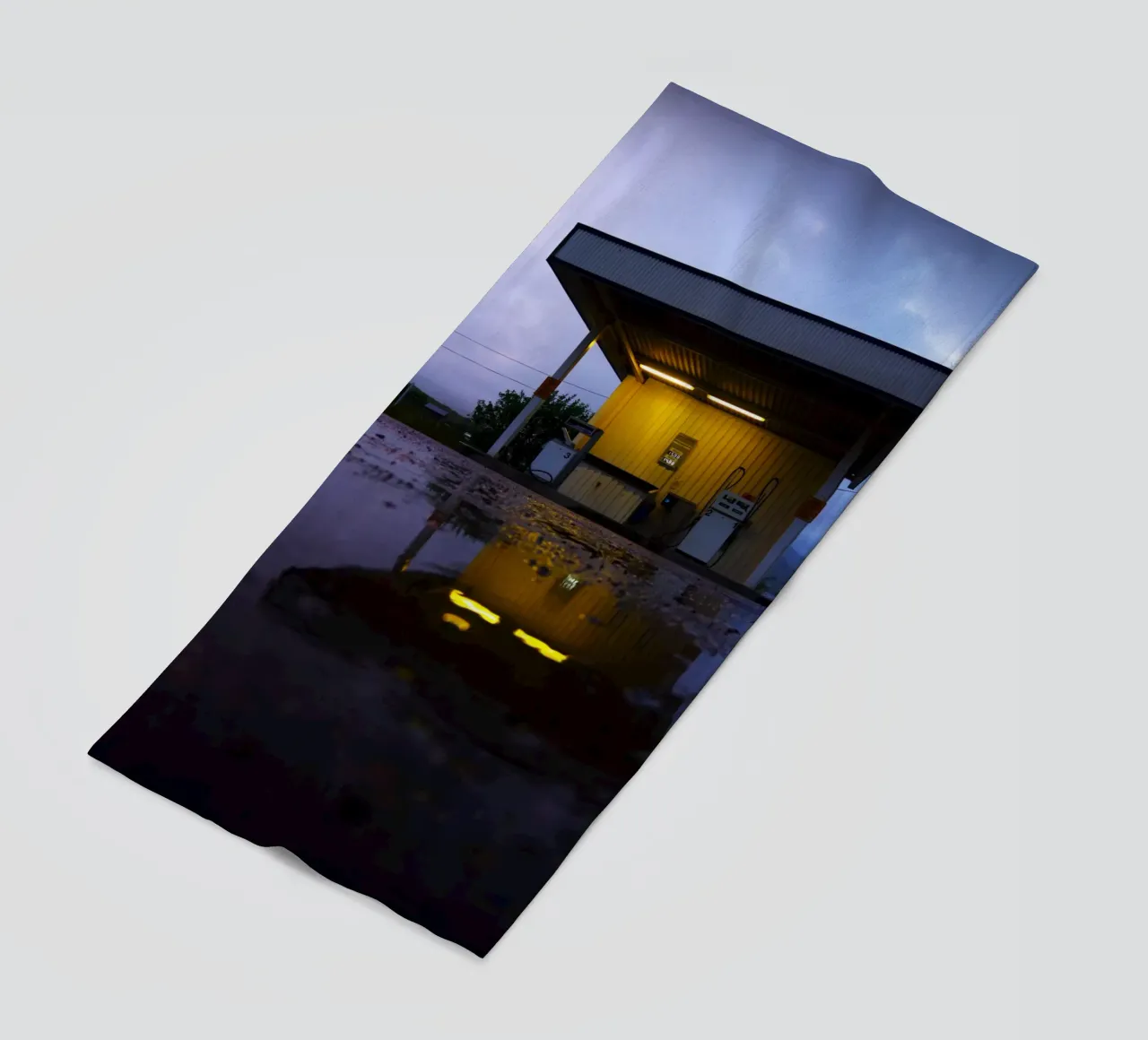 Lonely Gas Station beach towel by Fjöllart