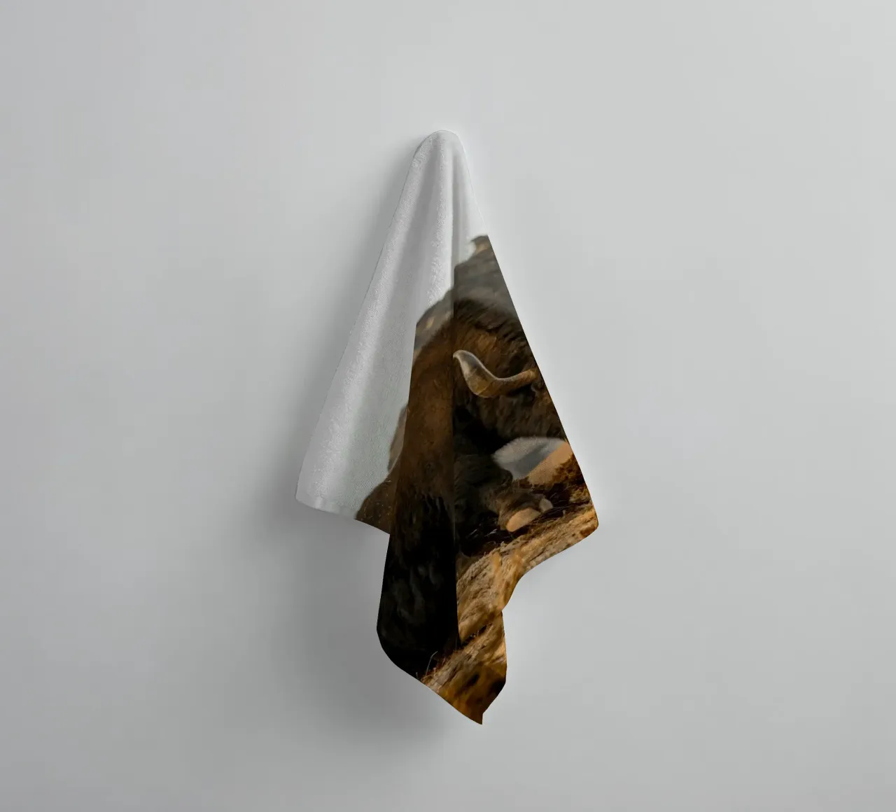A Yak Grazing on the Slopes of the Himalaya's towel by The Herringstore
