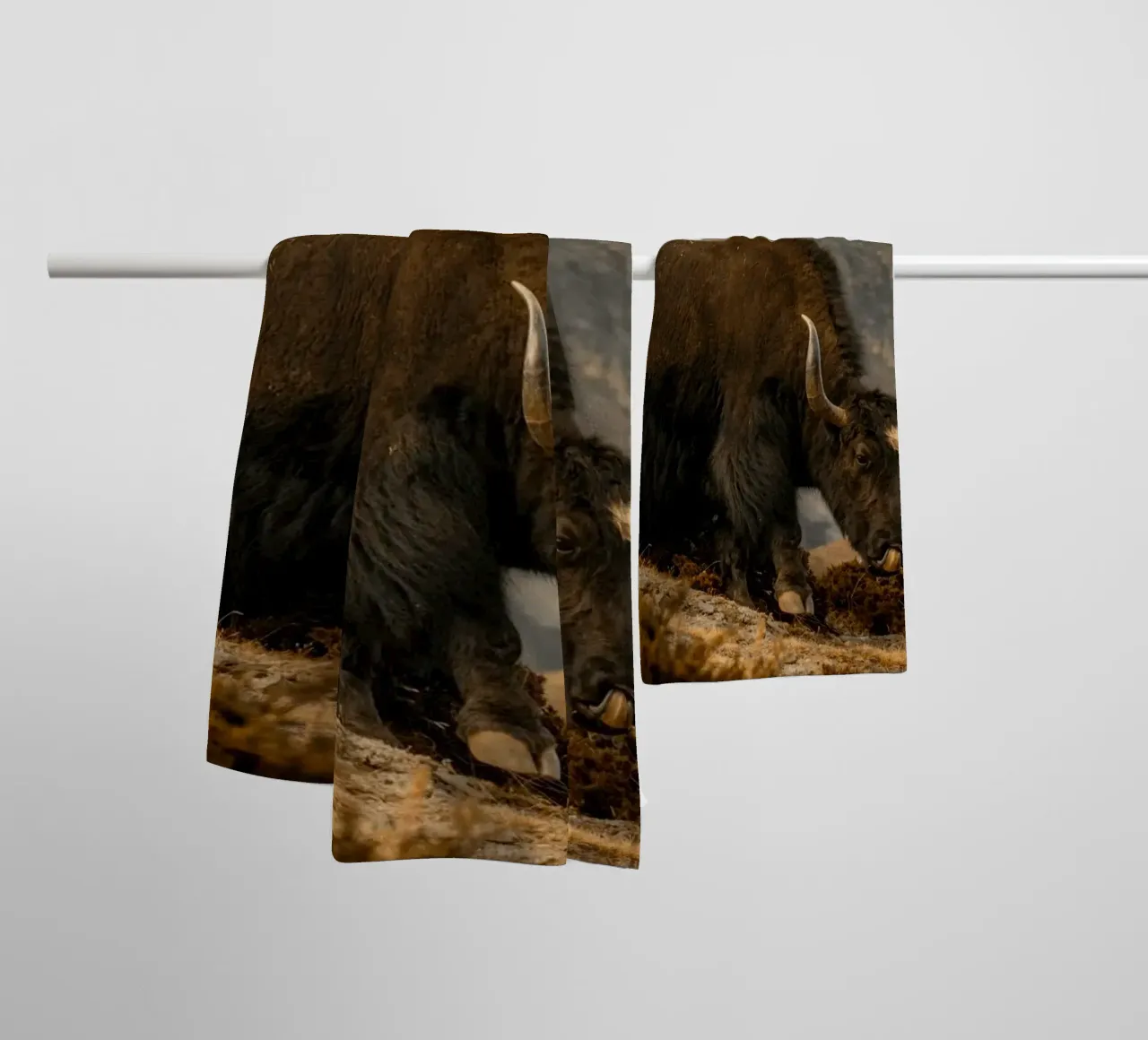 A Yak Grazing on the Slopes of the Himalaya's towel by The Herringstore