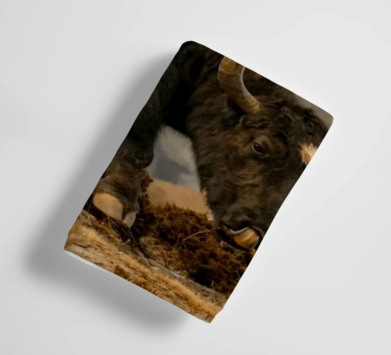 A Yak Grazing on the Slopes of the Himalaya's towel by The Herringstore