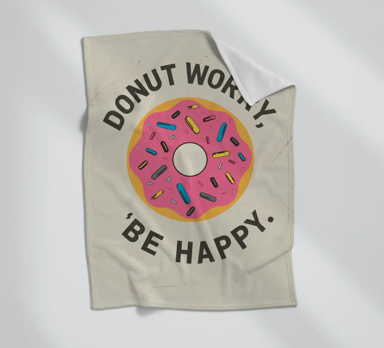Ciambella con "Donut Worry Be Happy" (Non preoccuparti, sii felice) coperta in pile da DesignDoodle