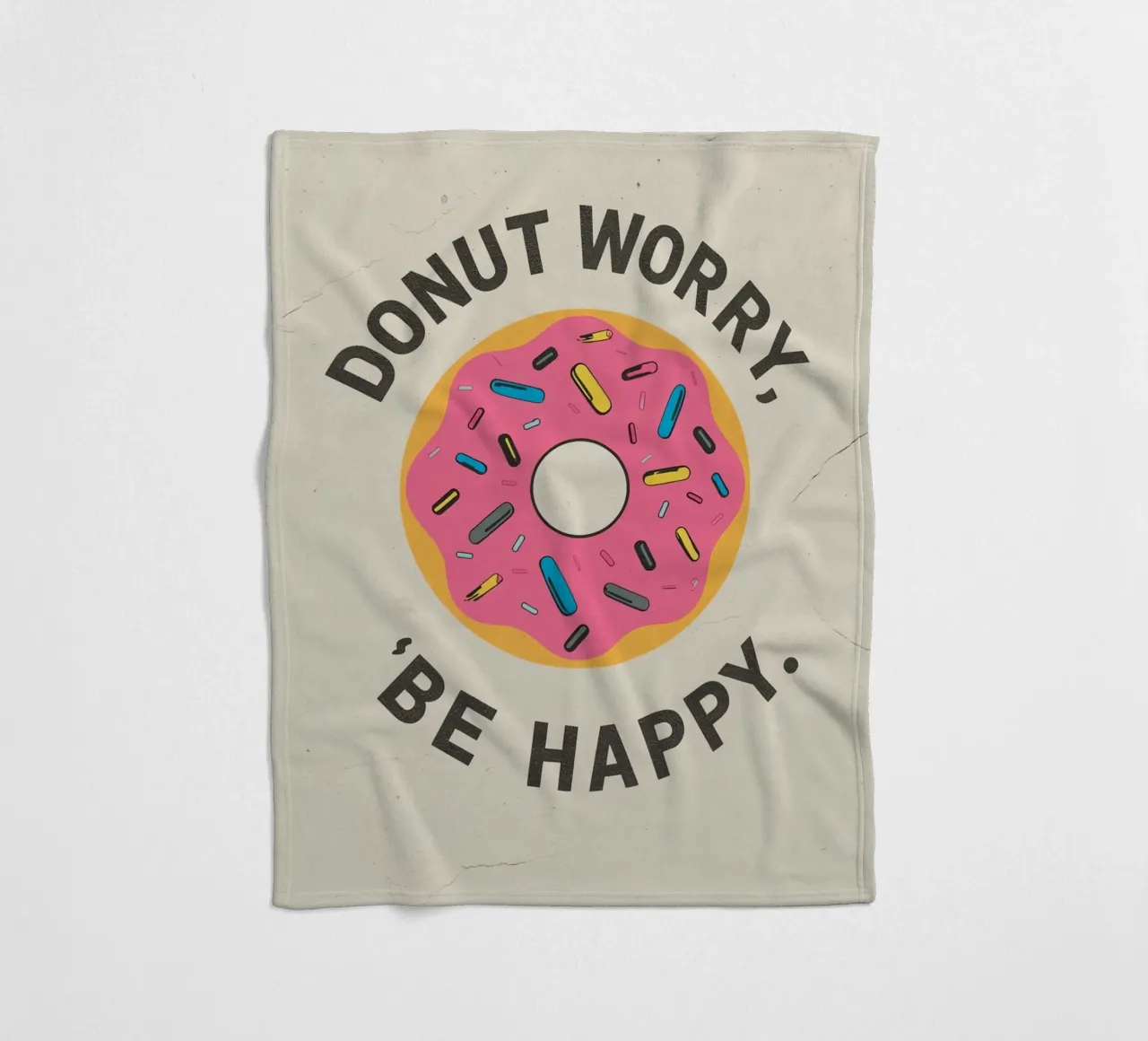 Ciambella con "Donut Worry Be Happy" (Non preoccuparti, sii felice) coperta in pile da DesignDoodle