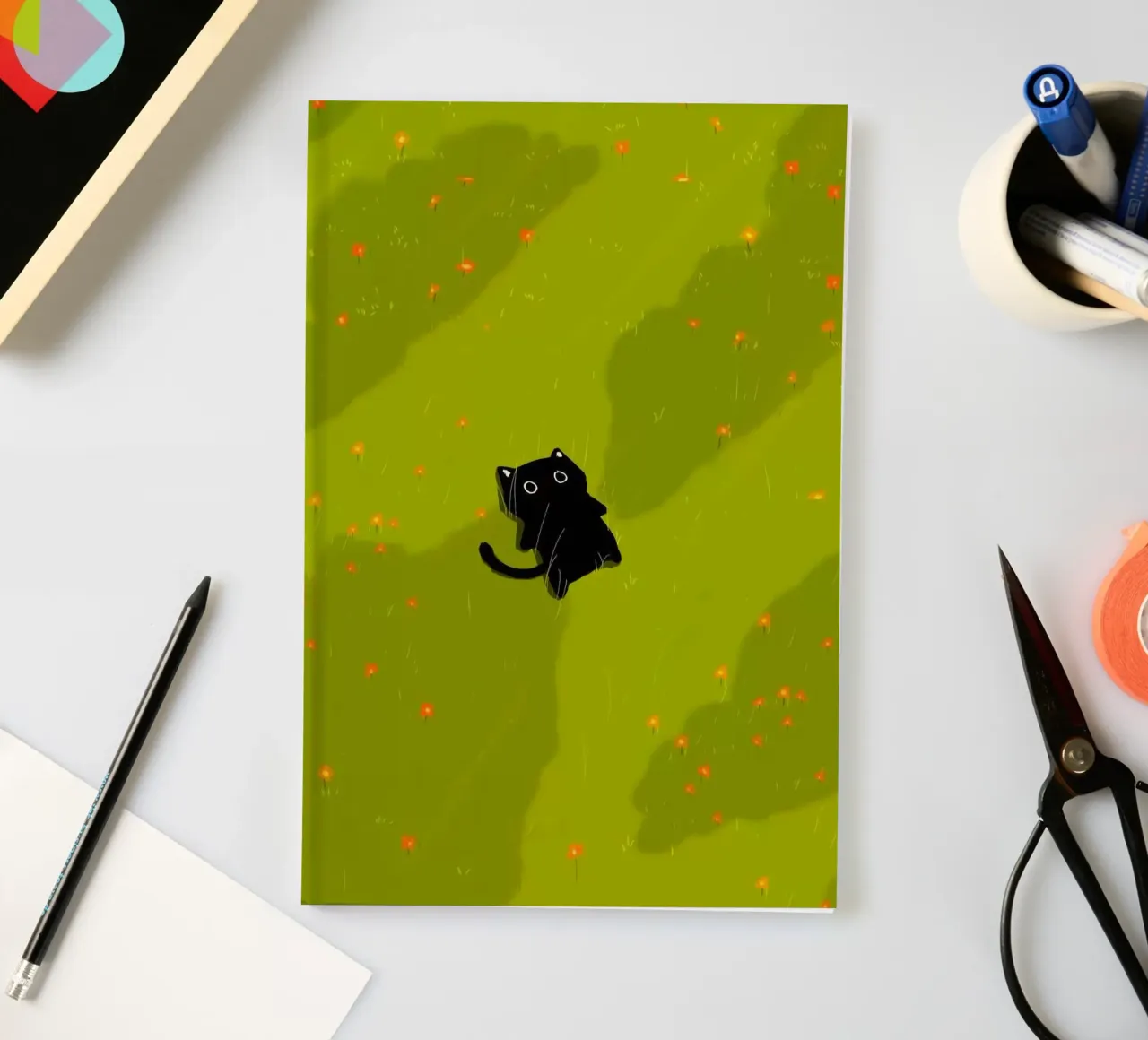 chill cat on green field notebook by Fost