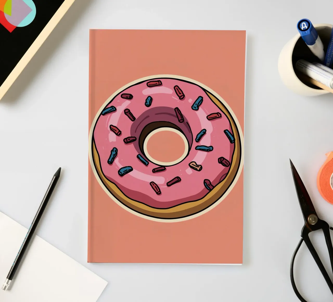 Pink frosted donut with sprinkles Sticker Design notebook by DesignDoodle