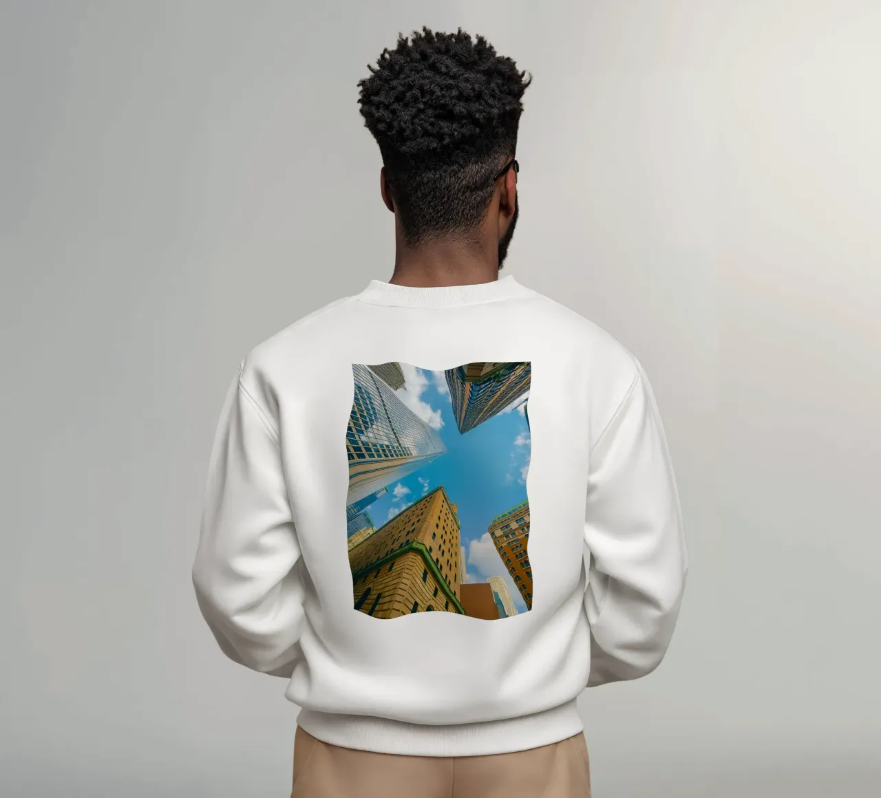 view of the sky from under a tall building sweatshirt by PASMING