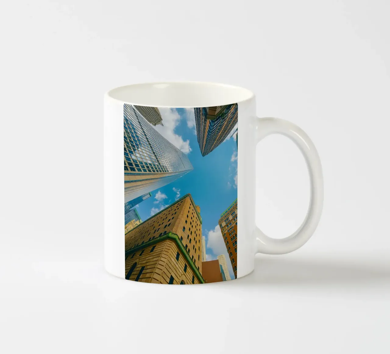 view of the sky from under a tall building ceramic mug by PASMING