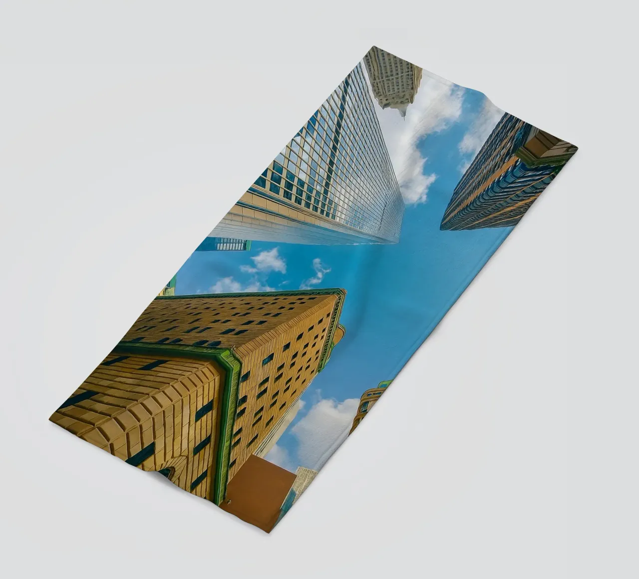 view of the sky from under a tall building beach towel by PASMING