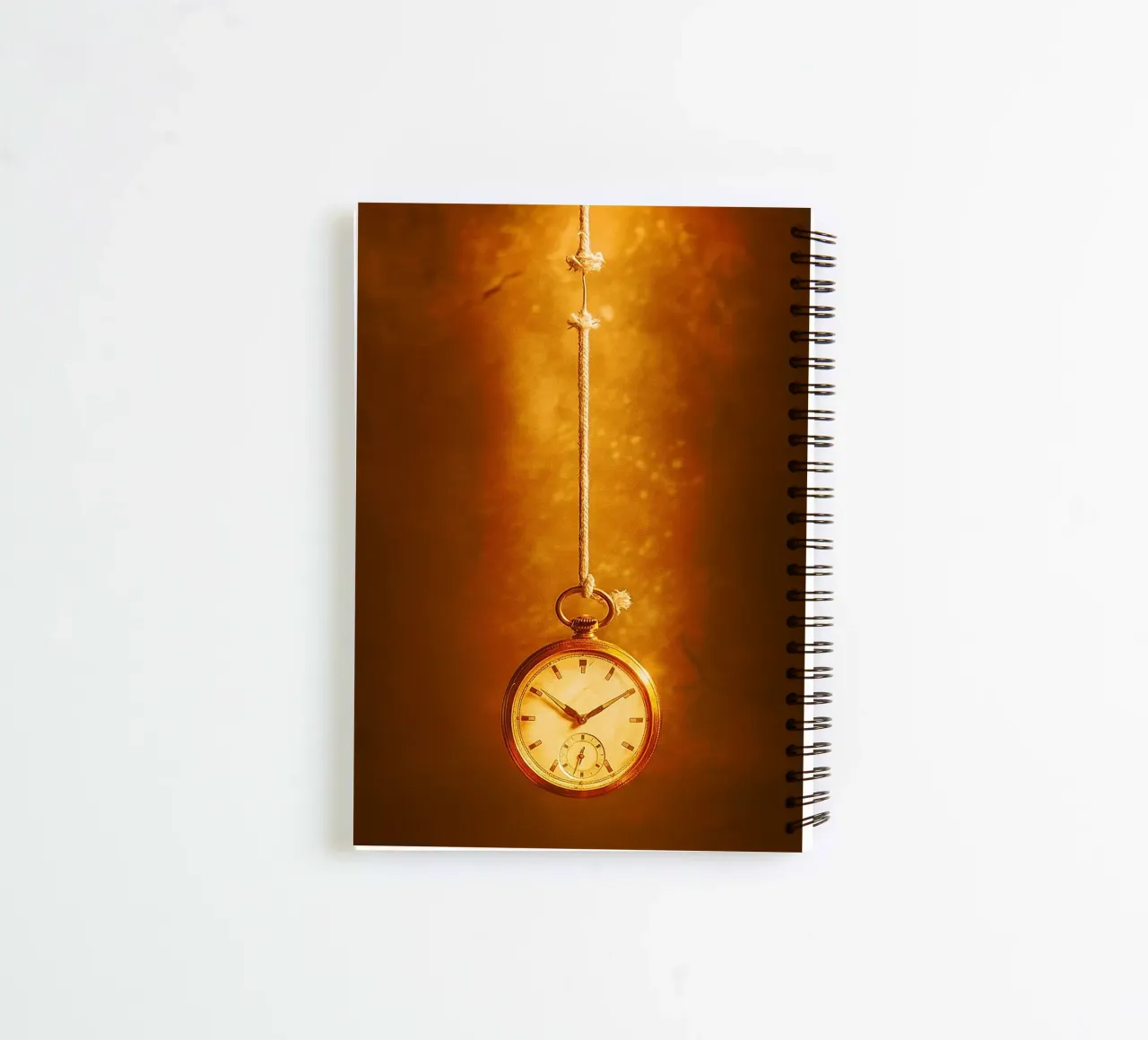 a clock hanging on a nearly broken string spiral notebook by PASMING