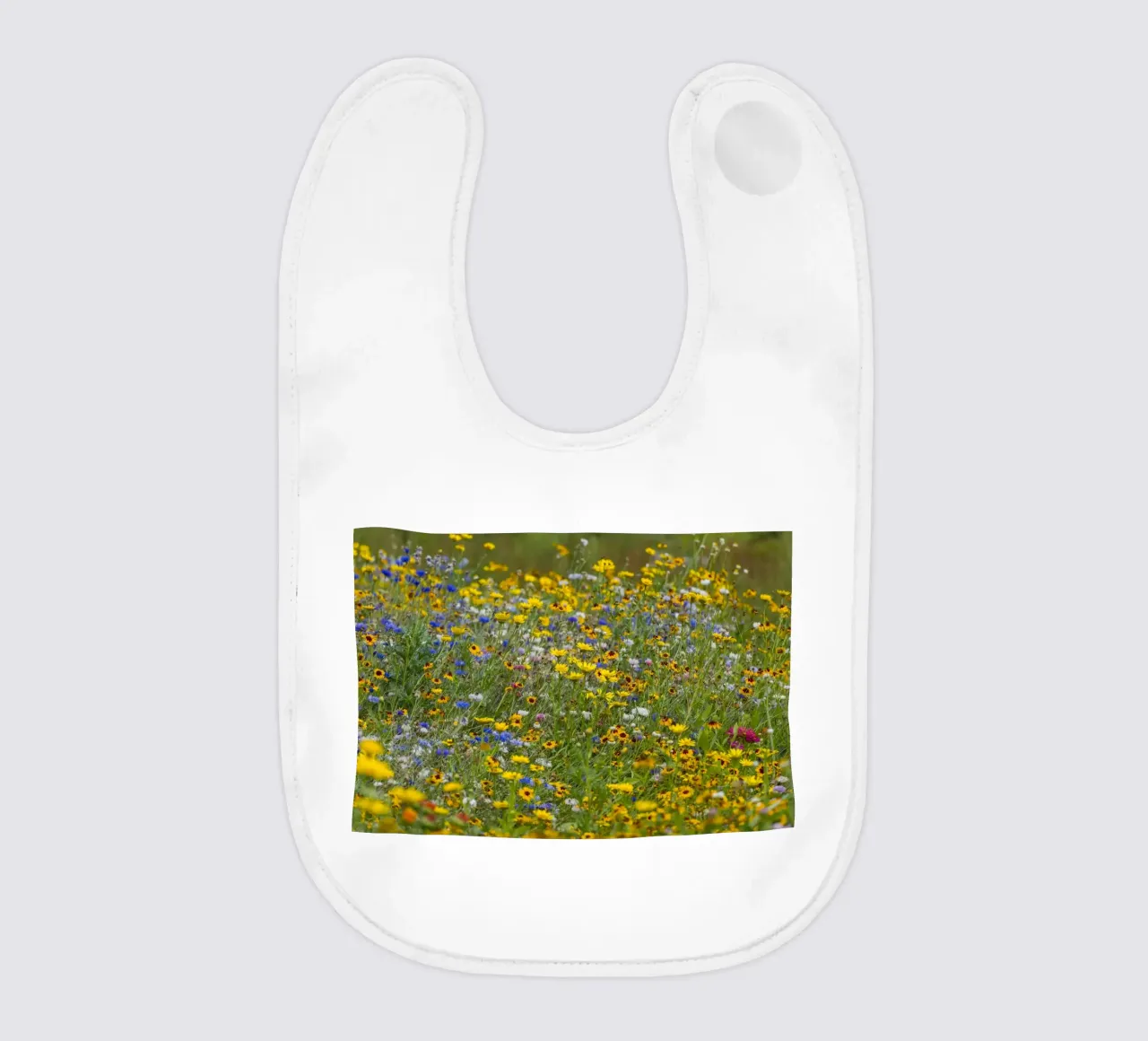 Flower filed with bright wild flowers babero de Curious Collections by Marielle Leenders
