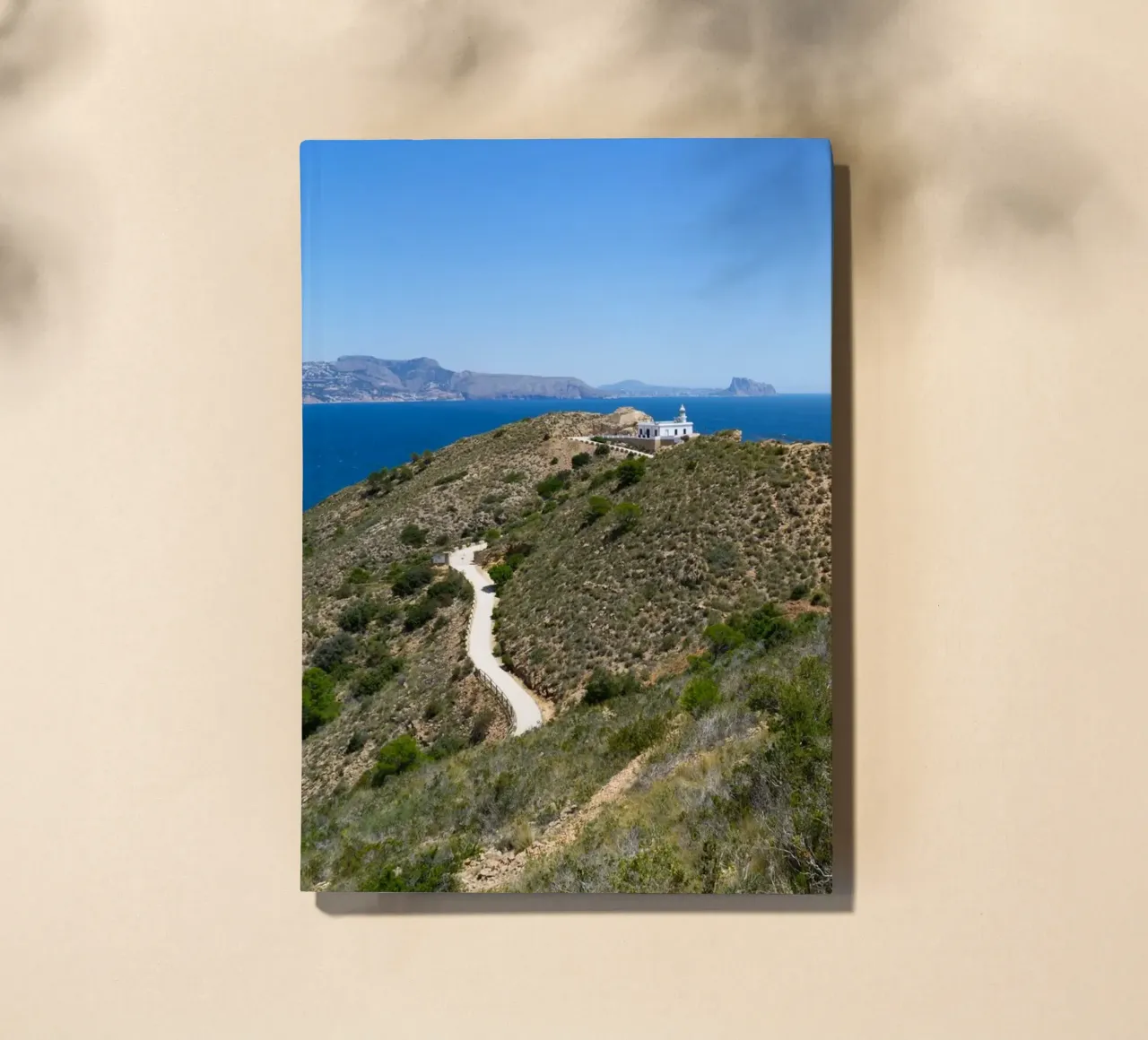 Cliffs and lighthouse on the Mediterranean notebook by Adriana Mueller