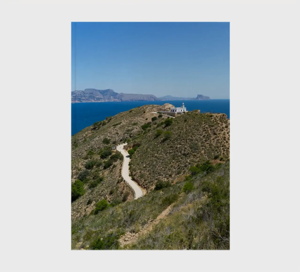 Cliffs and lighthouse on the Mediterranean notebook by Adriana Mueller