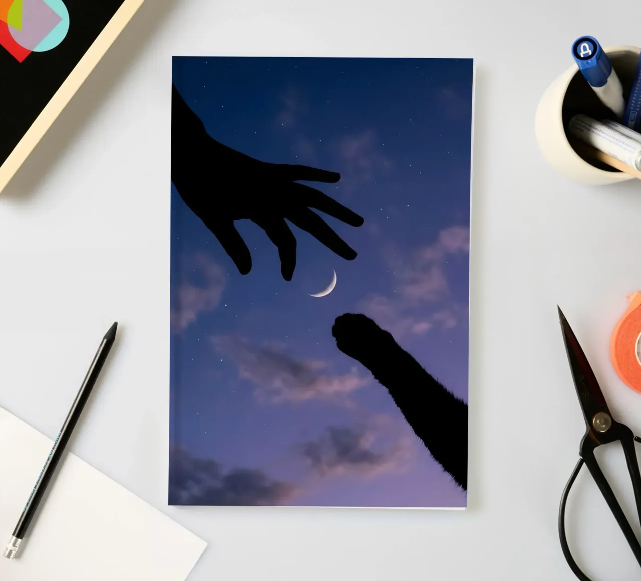 Hand and Cat Paw Reaching for the Crescent Moon Art Print notebook by Cosmic Reverie Studio