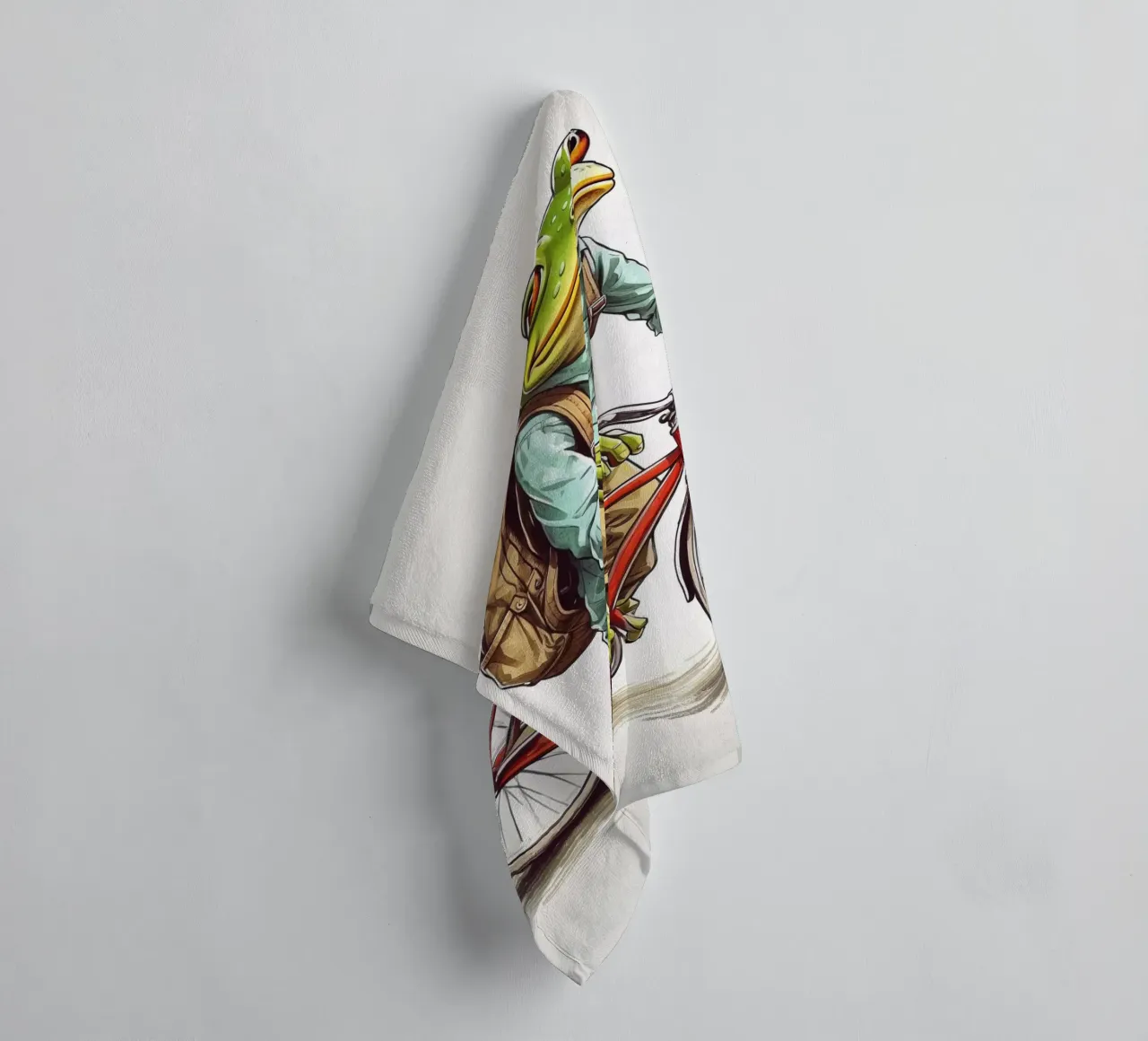 A frog on a bicycle towel by ARTVI-SHOP